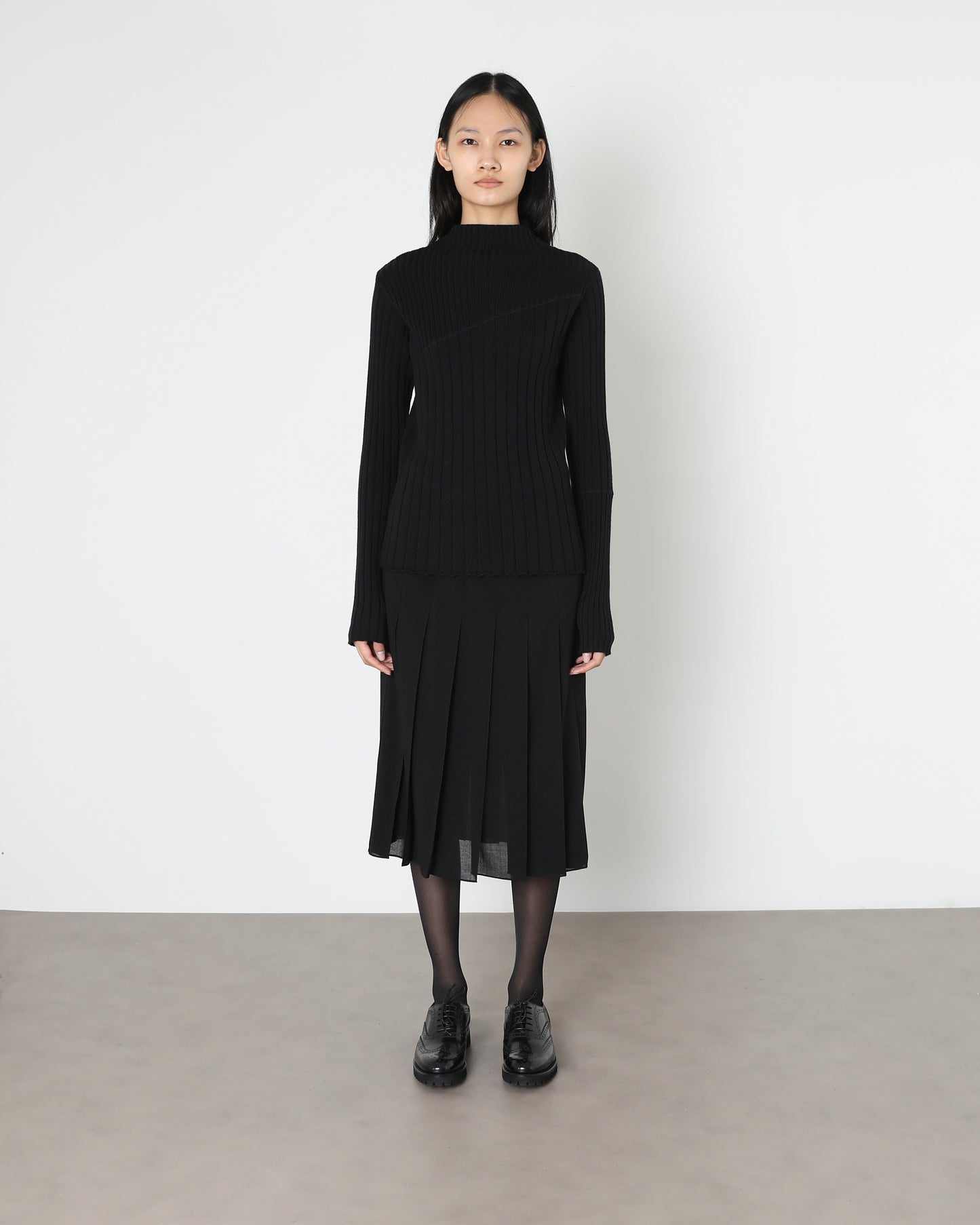 Model wears Issue Twelve Nina Rib Jumper in Black Wool
