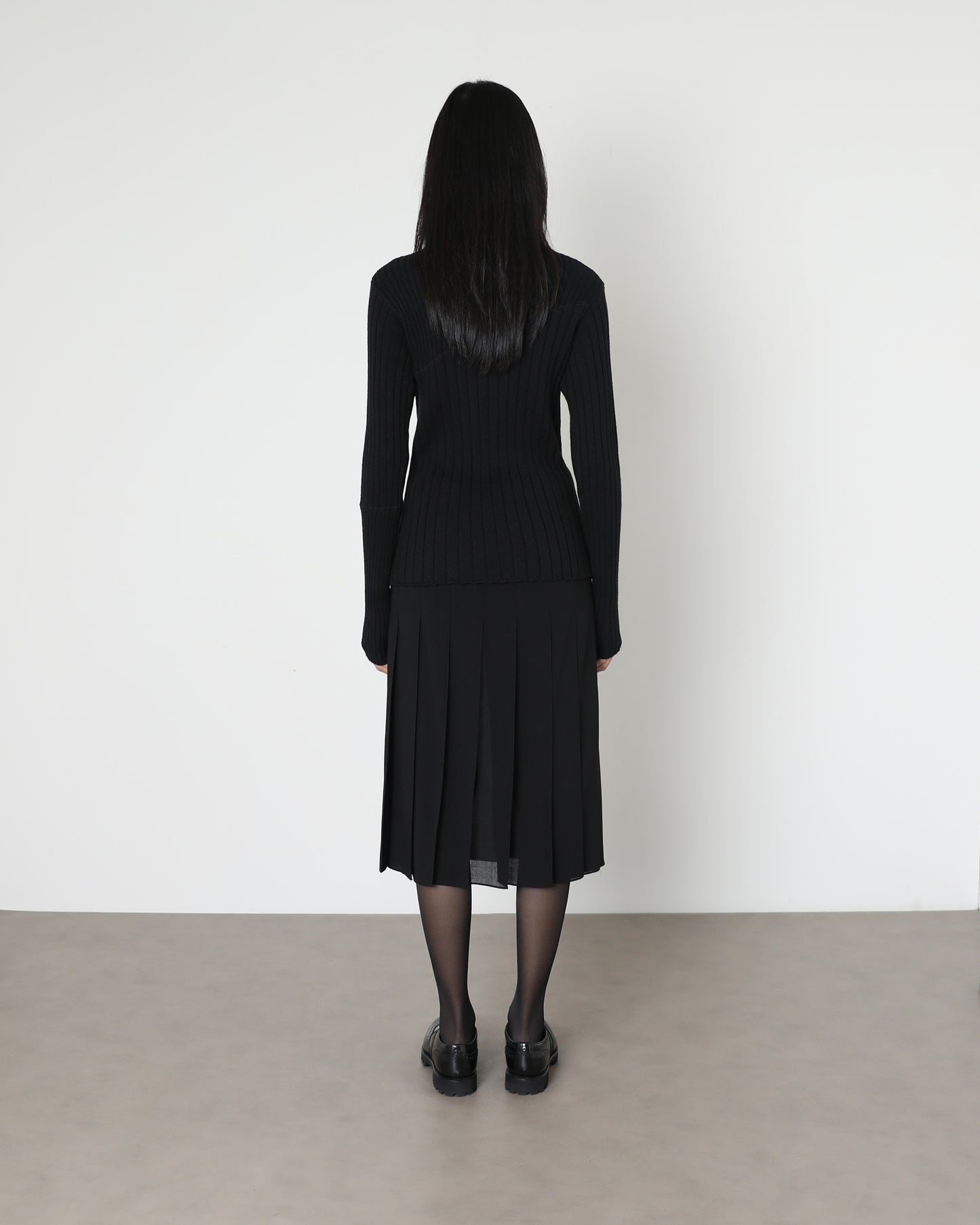 Model wears Issue Twelve Nina Rib Jumper in Black Wool