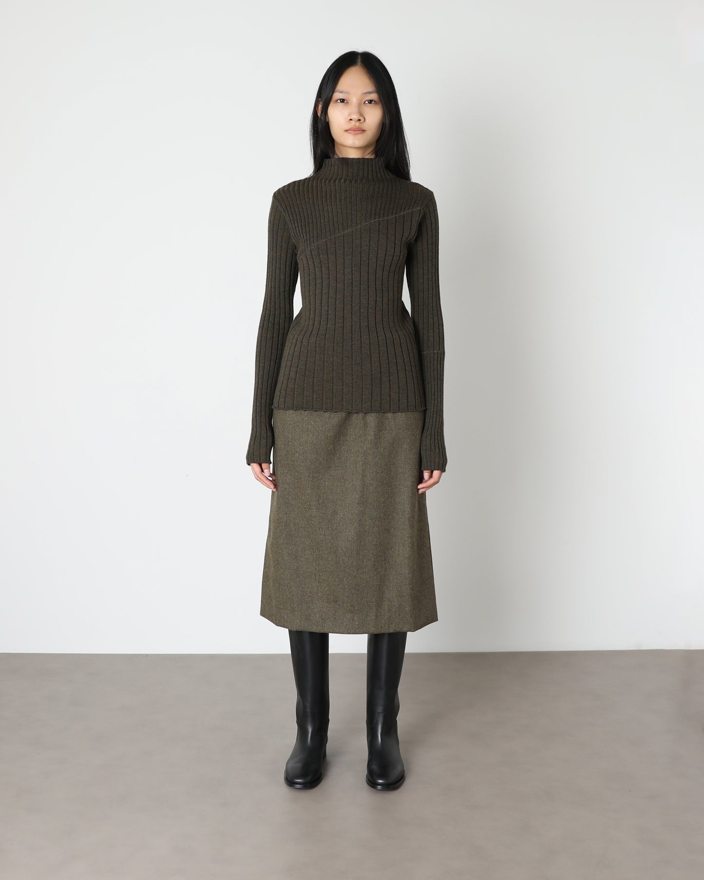 Model wears Issue Twelve Nina Jumper in Wool Green