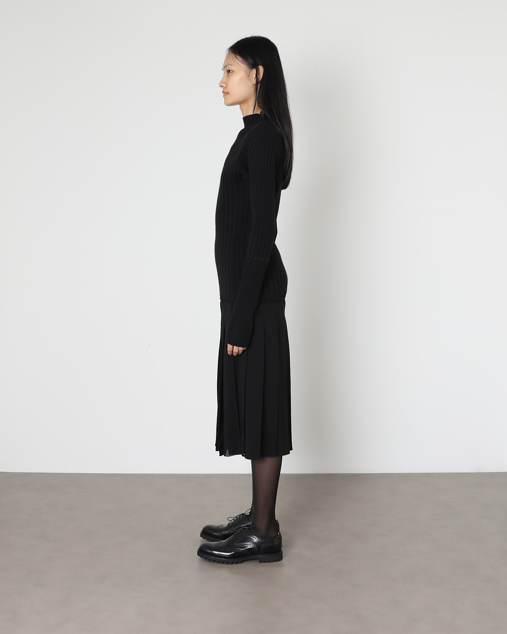 Model wears Issue Twelve Nina Rib Jumper in Black Wool