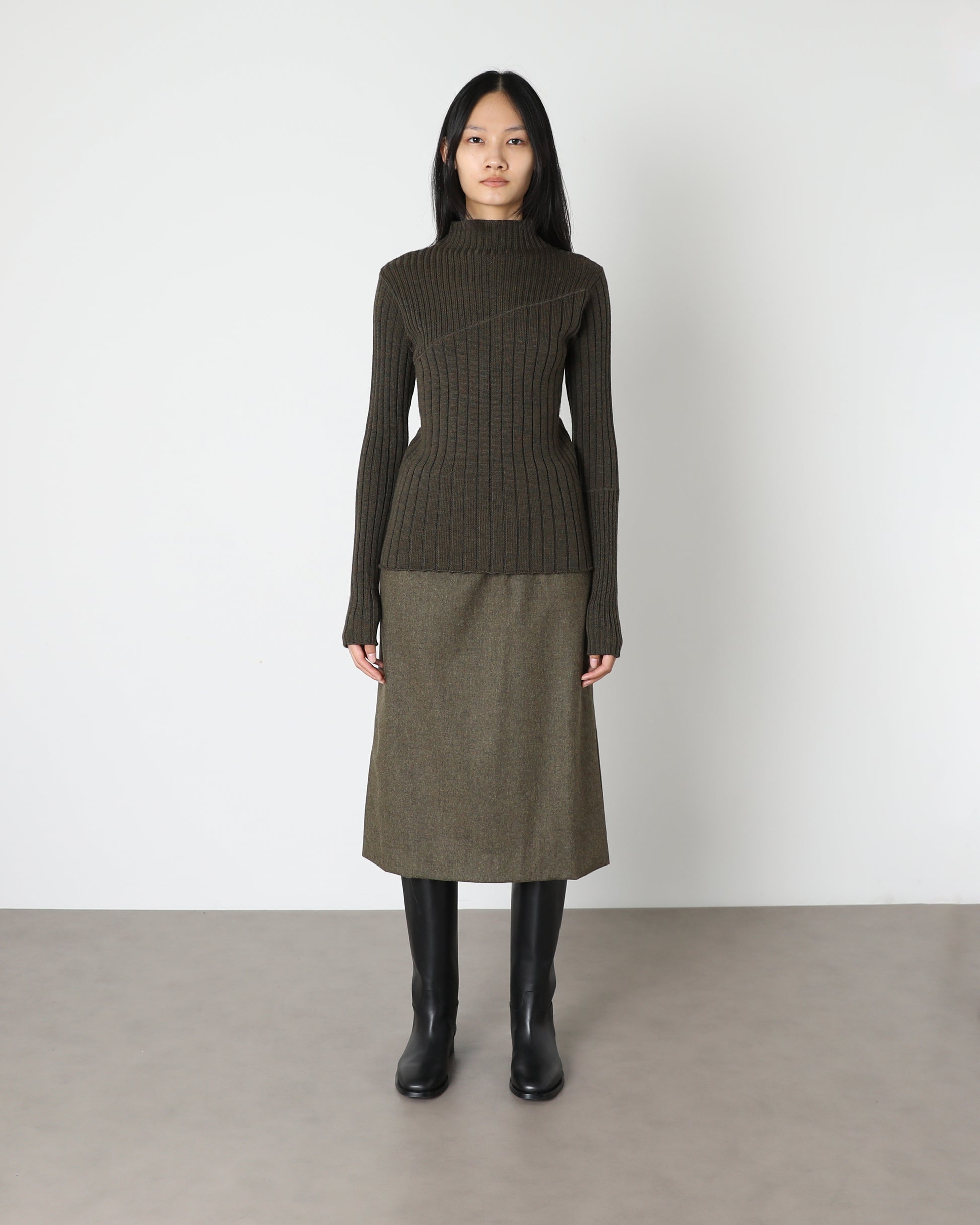 Model wears Issue Twelve Nina Jumper in Wool Green
