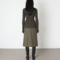 Model wears Issue Twelve Nina Jumper in Wool Green