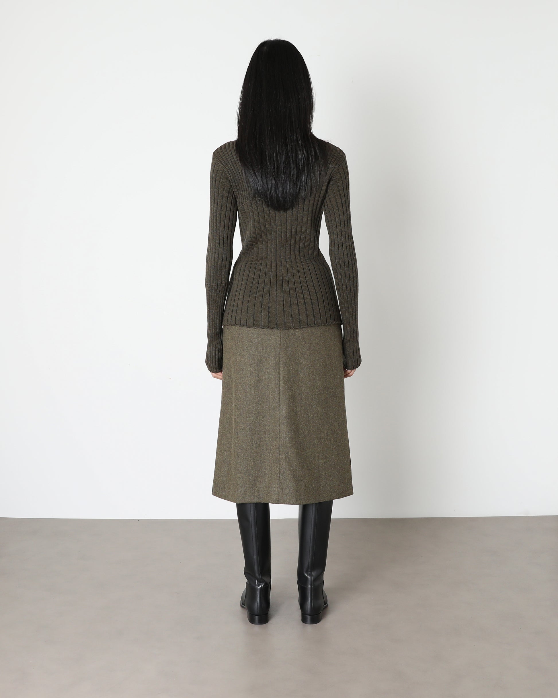 Model wears Issue Twelve Nina Jumper in Wool Green